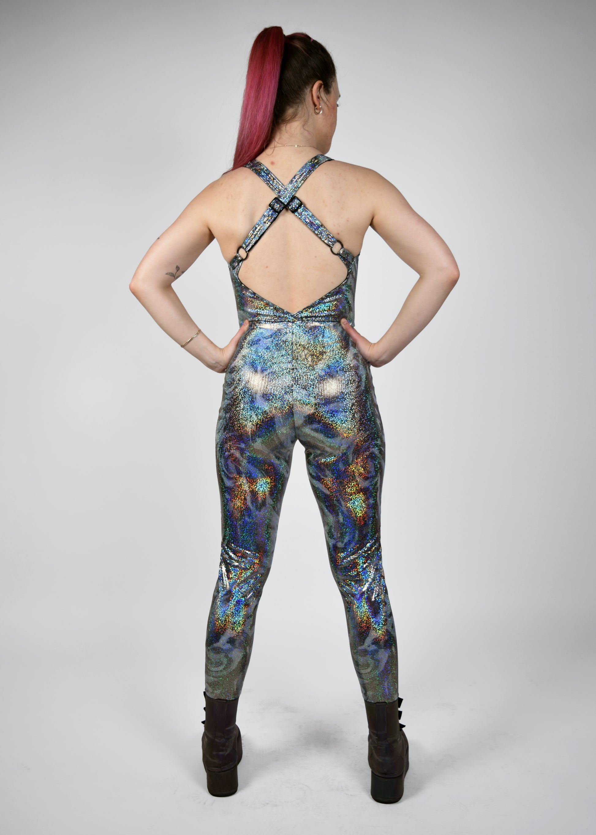 Womens music fesival fashion - Festival-outfit-rave-outfit - handmade-in-Brooklyn-New York City-custom made-waste conscious– retro style – hippie fashion –rave bralette top – festival jumpsuit - sleevless– retro style – supportive x back – adjustable straps - silver sparkly print - back view 