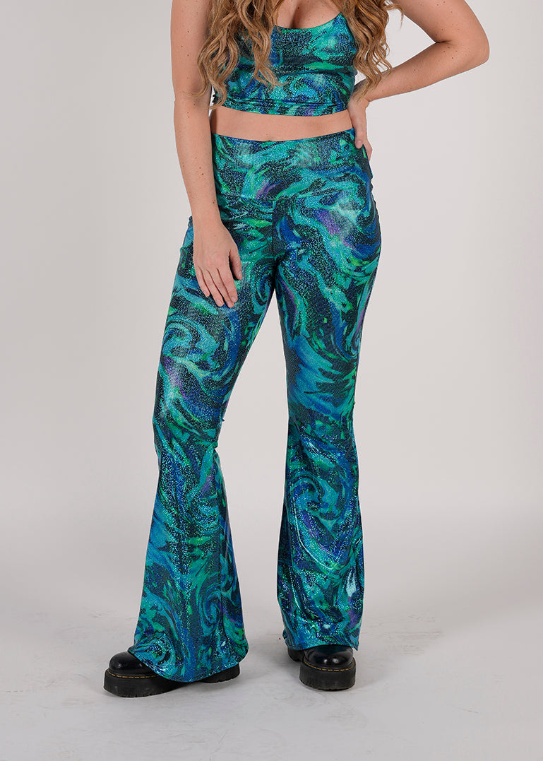  Unisex-Festival-outfit-rave-outfit - handmade-in-Brooklyn-New York City-custom made-waste conscious-groovy bellbottoms – retro style – hippie fashion – blue/green print on model - festival pants - rave pants
