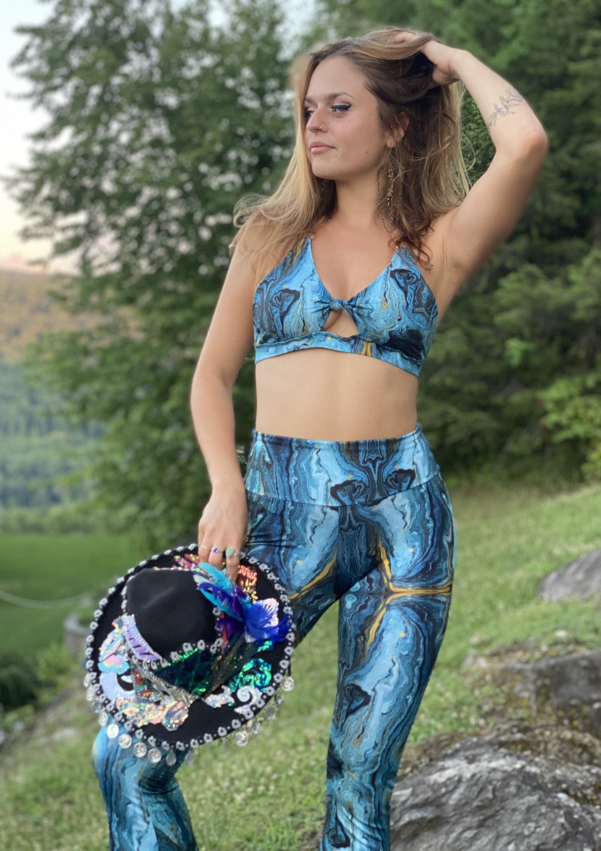 Womens music fesival fashion - Festival-outfit-rave-outfit - handmade-in-Brooklyn-New York City-custom made-waste conscious– retro style – hippie fashion – Knot Front Bra Top – front knot – rave bralette top – festival top - blue and gold geode print - side view on model